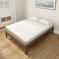Modern bedroom with a queen size wooden bed frame featuring a comfortable white mattress and pillows.