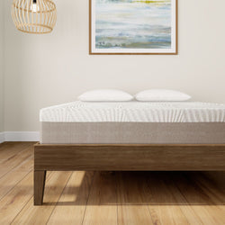 Modern wooden bed frame with comfortable mattress and pillows in a stylish bedroom setting.