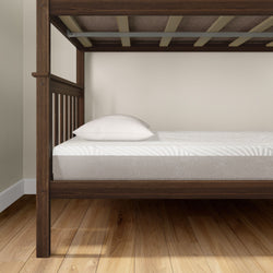 Wooden bunk bed with white mattress and pillow on hardwood floor.