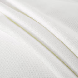 White textured fabric close-up, displaying soft and breathable material ideal for clothing and home textiles.
