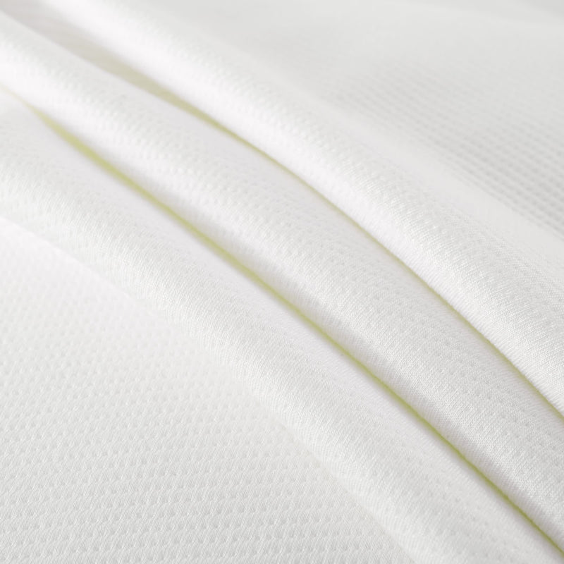 White textured fabric close-up, displaying soft and breathable material ideal for clothing and home textiles.