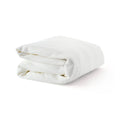 Folded white cotton blanket on white background.