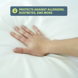 Hand on a hypoallergenic mattress cover protecting against allergens and dust mites.