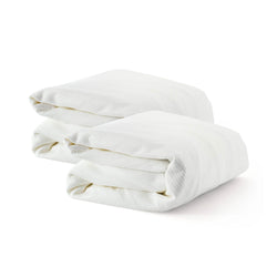 Two folded white cotton bed sheets neatly stacked against a white background.