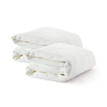 Two folded white cotton bed sheets neatly stacked against a white background.