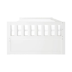 Front view of a white wooden convertible crib/toddler bed with vertical slatted guardrail and solid panel footboard, modern nursery furniture
