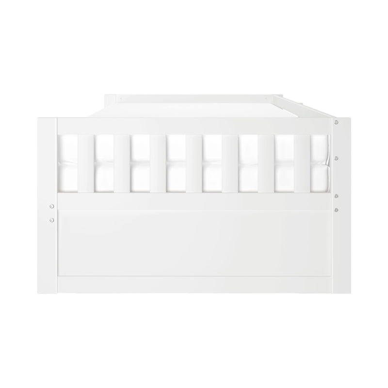 Front view of a white wooden convertible crib/toddler bed with vertical slatted guardrail and solid panel footboard, modern nursery furniture