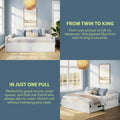 White convertible daybed that flips from twin to king with pull-out trundle and built-in storage drawers in a light-blue guest bedroom