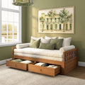 Light-filled guest room with wooden daybed, under-bed storage drawers, green throw pillows and framed watercolor wall art