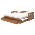 Wooden storage daybed with white mattress, slatted backrest and two pull-out underbed drawers in warm oak finish