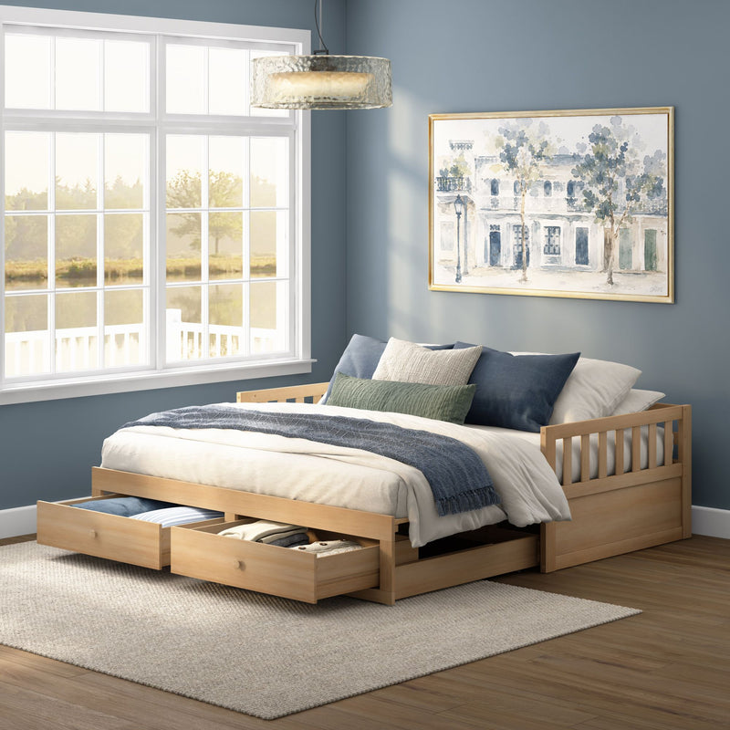 Wood platform bed with under-bed storage drawers, neutral bedding and blue accent wall in a sunlit modern coastal bedroom with large window, pendant light and framed watercolor wall art