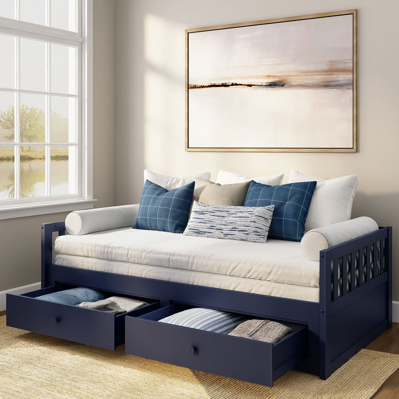 Navy blue wooden daybed with under-bed storage drawers, white twin mattress, blue plaid and striped throw pillows and framed abstract wall art in a sunlit guest room