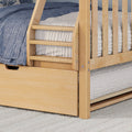 Close-up of natural wood bunk bed ladder and safety rails with blue quilted bedding and under-bed storage drawer