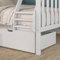 Close-up of white wooden bunk bed ladder with pull-out storage drawer, neutral linen bedding and woven jute rug in modern kids' bedroom