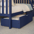 Navy blue wooden twin-over-twin bunk bed with pull-out trundle drawer, cream bedding and light blue throw on gray carpet — space-saving kids' bedroom furniture