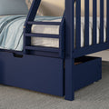 Close-up of navy blue wooden bunk bed ladder and built-in storage drawer with light blue bedding and gray mattress on a carpeted floor in a modern kids' bedroom
