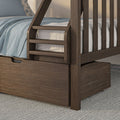 Dark brown solid wood bunk bed with built-in ladder and under-bed storage drawer, light blue bedding and floral pillow in modern bedroom