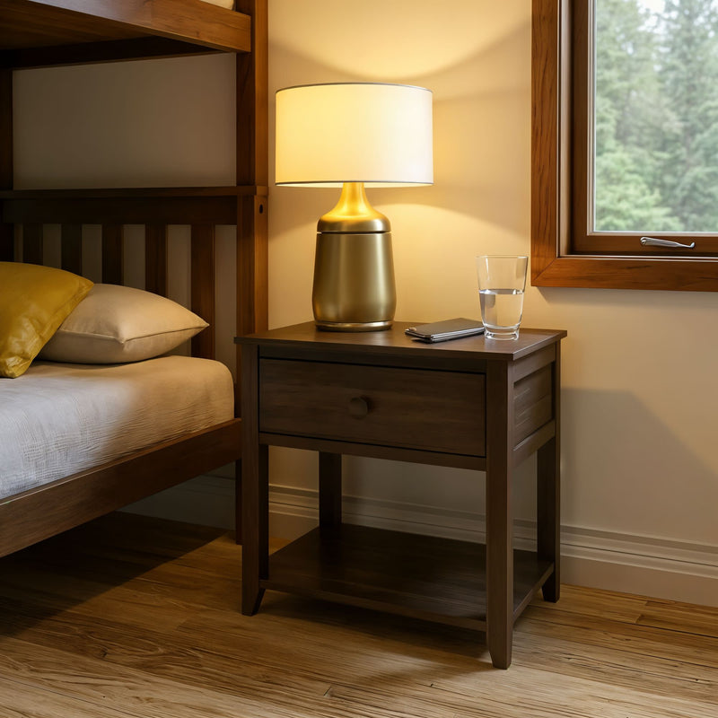 Modern bedroom with wooden nightstand, stylish lamp, and cozy bed near a window.