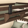Wooden bunk bed with attached tray holding a black water bottle and green bedding set.