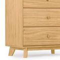 Light oak mid-century modern wooden dresser corner with two drawers, round wooden knobs and tapered angled legs for bedroom storage