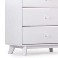 White mid-century modern wooden dresser with two drawers, round knobs and tapered legs, minimalist bedroom storage chest