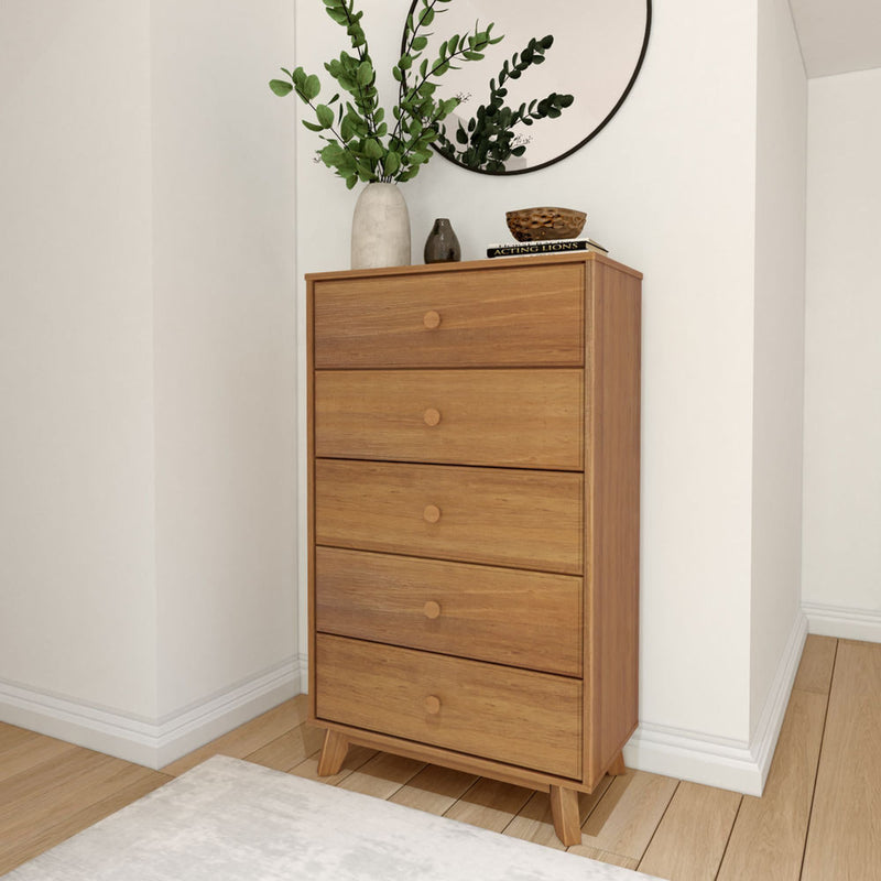Wooden tallboy dresser with plants and mirror in modern bedroom setting.