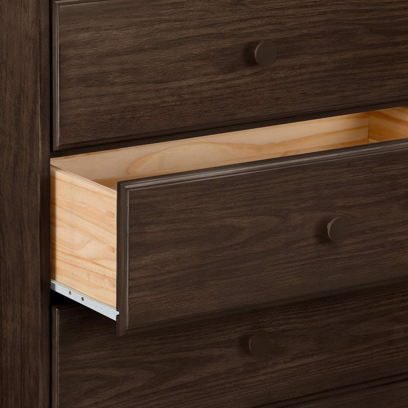 Dark walnut bedroom dresser with a partially open drawer revealing natural wood interior and round wood knobs