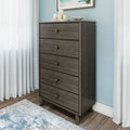Mid-century modern tall five-drawer gray oak dresser chest of drawers in bedroom with blue accent wall, white curtains and hardwood floor
