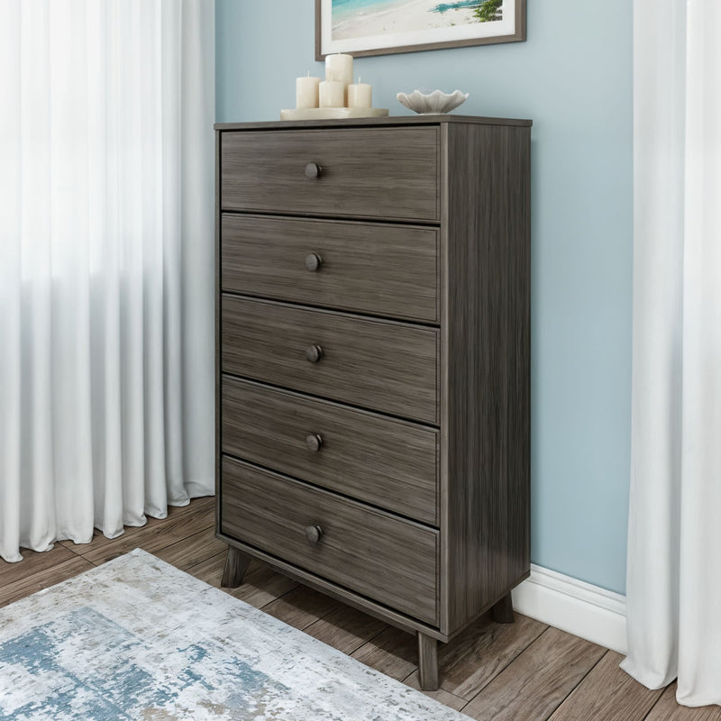 Mid-century modern tall five-drawer gray oak dresser chest of drawers in bedroom with blue accent wall, white curtains and hardwood floor
