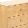 Light natural pine three-drawer dresser with round wooden knobs and smooth wood grain finish, minimalist bedroom storage chest