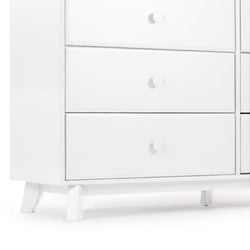 White mid-century modern wooden dresser with three drawers, round knobs and tapered legs, minimalist white bedroom storage cabinet