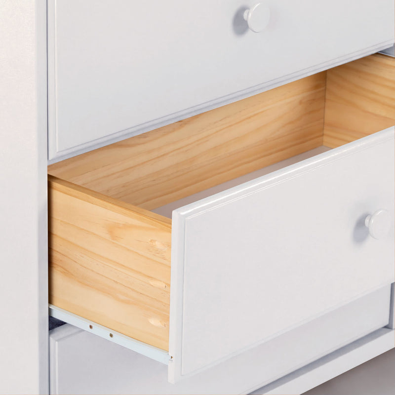 White wooden dresser with open drawer revealing natural pine interior, modern bedroom storage dresser with round knobs