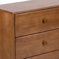 Wooden dresser with two drawers and round handles, featuring a smooth polished finish.