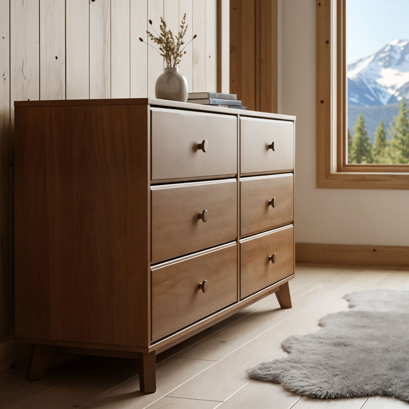 Mid-century modern six-drawer wooden dresser in a rustic Scandinavian bedroom with natural wood walls, sheepskin rug and mountain view