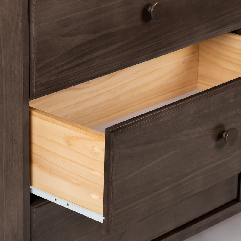 Open dark brown wooden dresser drawer with natural pine interior and metal drawer slides, bedroom storage furniture close-up