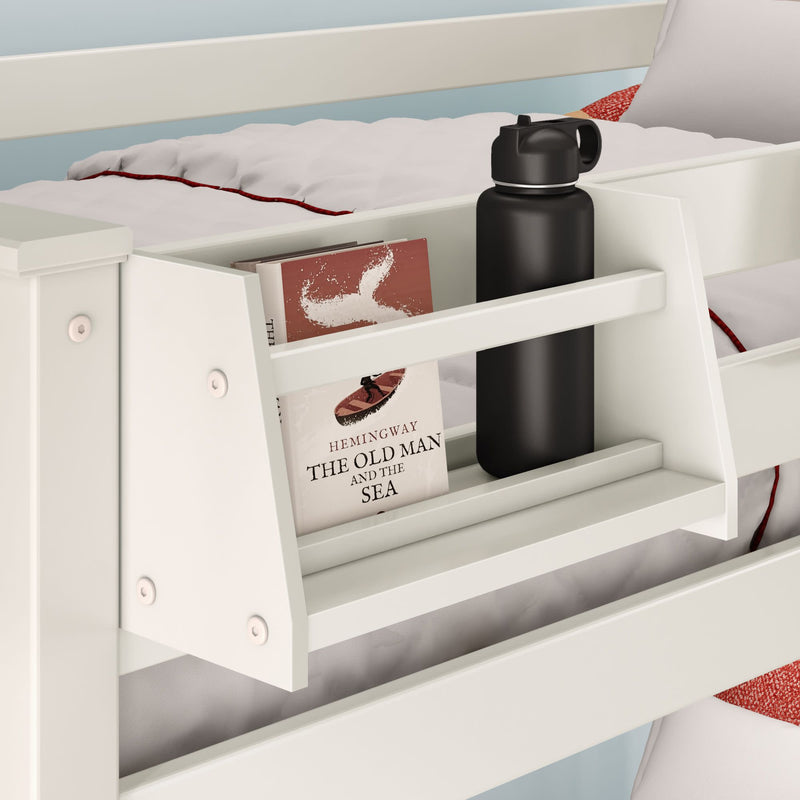 White bed with built-in storage shelf holding a book and a black water bottle, ideal for small spaces.