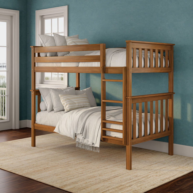 Solid wooden bunk bed with ladder and neutral linens in a coastal-style teal bedroom with large windows, hardwood floors and natural jute rug