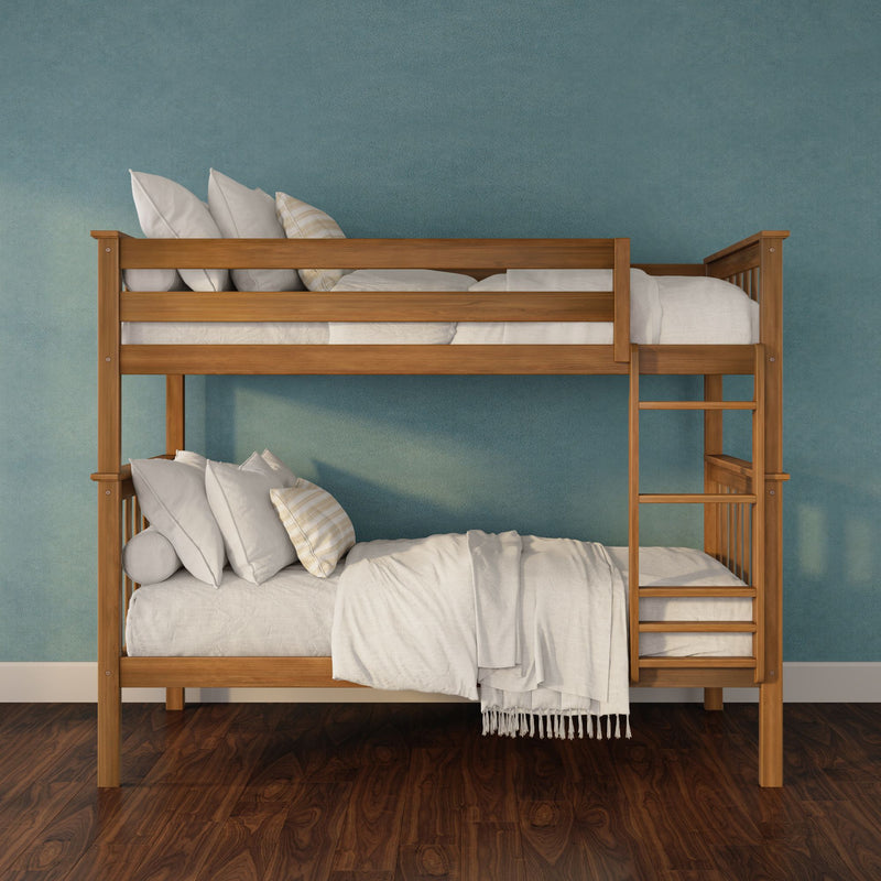 Wooden bunk bed with natural finish, white bedding and pillows against a teal wall on dark hardwood floor