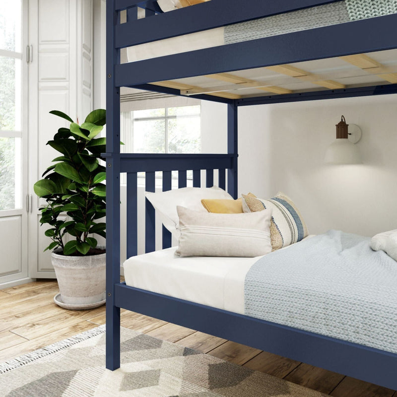 Blue bunk bed in a cozy bedroom with natural light, indoor plant, and soft pillows.