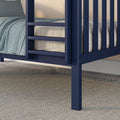 Close-up of navy blue bunk bed ladder and leg with textured light-blue bedding and neutral mattress on a beige carpeted bedroom floor