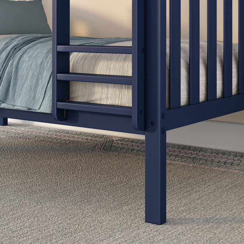 Close-up of navy blue bunk bed ladder and leg with textured light-blue bedding and neutral mattress on a beige carpeted bedroom floor