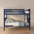 Navy blue wooden twin-over-twin bunk bed with ladder, cream and light blue bedding and floral pillows in a cozy kids' bedroom with hardwood floor and beige wall