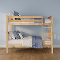 Light wood bunk bed with blue and white quilts and pillows, ladder and hardwood floor against a pastel blue kids' bedroom wall