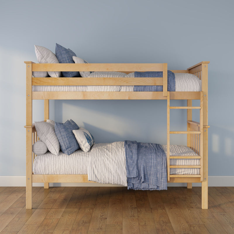 Light wood bunk bed with blue and white quilts and pillows, ladder and hardwood floor against a pastel blue kids' bedroom wall