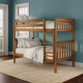 Solid wood bunk bed in a coastal-style kids bedroom with teal walls, white-trim windows, neutral linen bedding, wooden ladder and natural jute rug