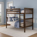 Dark wood bunk bed with ladder, white quilt and blue pillows in bright coastal bedroom