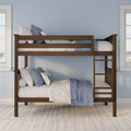 Wooden bunk bed with blue and white quilted bedding, ladder and safety rails in a light-blue kids' bedroom