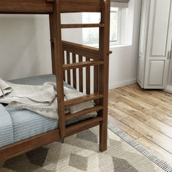 Wooden bunk bed with ladder, blue bedding, and light hardwood floor in a modern bedroom setting.