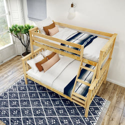 Wooden bunk bed with white and blue bedding in a bright, cozy room featuring a patterned rug and natural light.
