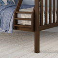 Close-up of dark walnut wooden bed ladder and slatted frame with blue quilt, white mattress and textured beige rug